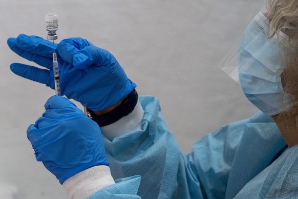 A pharmacist fills a dead volume syringe with the Pfizer-BioNTech COVID-19 Vaccine at a pop-up COVID-19 vaccination site at St. Luke&#039;s Episcopal Church, Tuesday, Jan. 26, 2021, in the Bronx borou ...