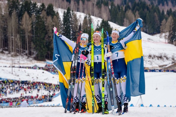Gold medalist Linn Svahn, center, silver medalist Jonna Sundling, left, and bronze medalist Maja Dahlqvist, all three of Sweden, pose after the cross-country skiing women's sprint classic at the  ...