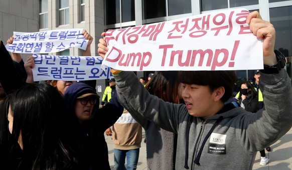 epa06305299 South Korean protesters shout slogans and hold banners reading 'Trump! Don't come to Korea' during a rally held to show opposition to the US President's upcoming visit to South Korea, in f ...