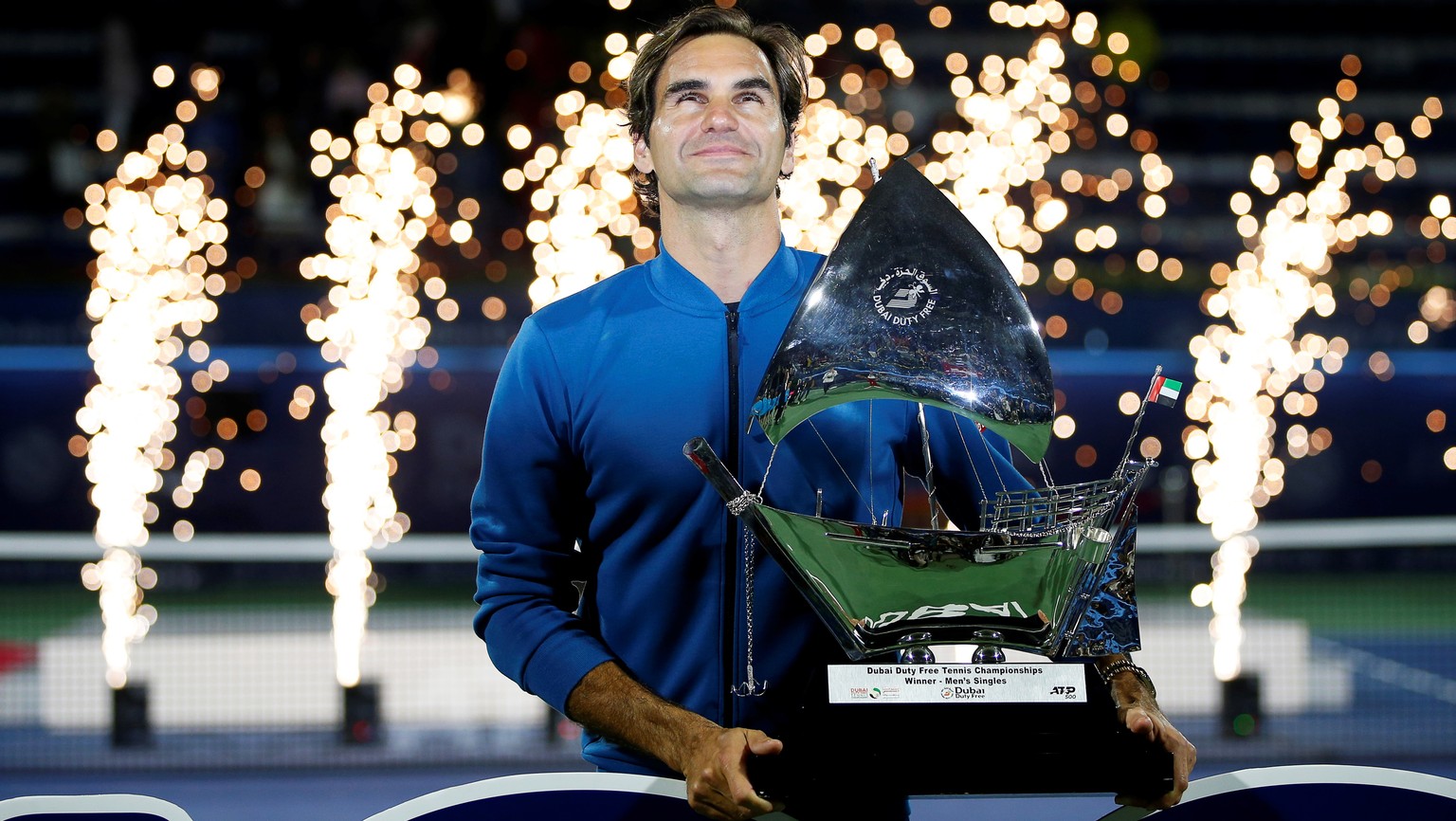 epa07409160 Roger Federer of Switzerland poses with his trophy after defeating Stefanos Tsitsipas of Greece in their final match at the Dubai Duty Free Tennis ATP Championships 2019 in Dubai, United A ...