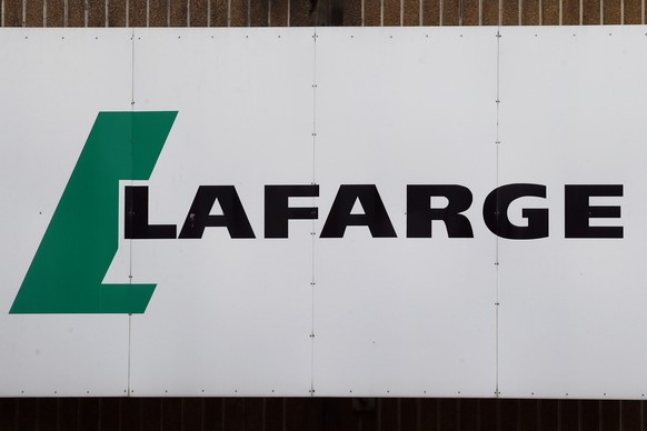 FILE - A logo of Lafarge, the world&#039;s largest cement maker, is pictured outside of a facility, in Paris, Sept. 8, 2017. Lafarge has pleaded guilty to paying $17 million to the Islamic State group ...
