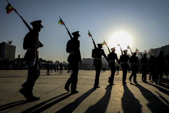 FILE - Ethiopian military parade with national flags attached to their rifles at a rally organized by local authorities to show support for the Ethiopian National Defense Force (ENDF), at Meskel squar ...