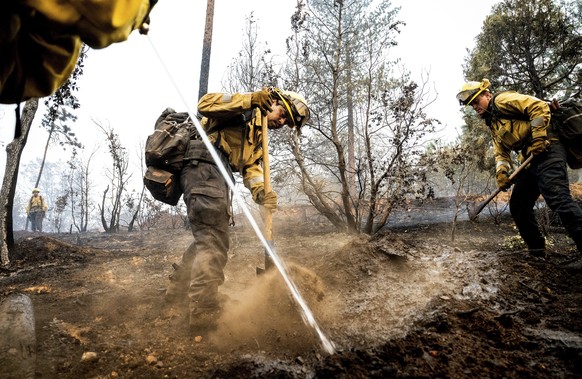 Firefighter Sergio Porras mops up hot spots while battling the Oak Fire in the Jerseydale community of Mariposa County, Calif., on Monday, July 25, 2022. He is part of Task Force Rattlesnake, a progra ...