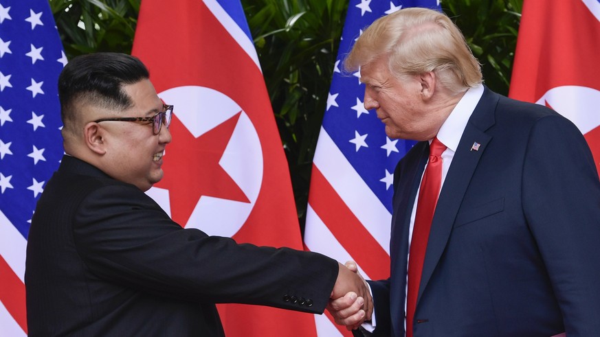 FILE - In this June 12, 2018, file photo, North Korea leader Kim Jong Un, left, and U.S. President Donald Trump shake hands at the conclusion of their meetings at the Capella resort on Sentosa Island  ...