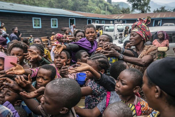 People who fled Goma, Congo, gather at a food distribution point Friday, May 28, 2021 in Sake, some 25 kms (16 miles) west of Goma where they found shelter following an official evacuation order five  ...