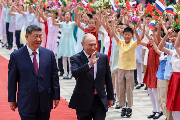 Russian President Vladimir Putin, center, and Chinese President Xi Jinping attend a welcome ceremony at the Great Hall of the People, in Beijing, China, on Wednesday, May 20, 2026. (Alexander Kazakov, ...