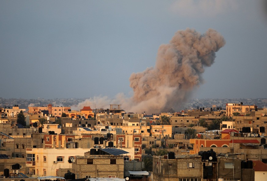 Smoke plumes rising above buildings during an Israeli strike on Rafah in the southern Gaza Strip, Saturday October 14, 2023.. International aid groups and major powers have pleaded with Israel to set  ...