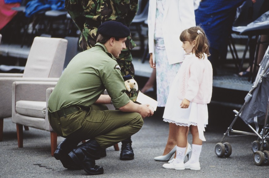 British Royal Prince Andrew, Duke of York, speaking with a young girl as he meets the families of military personnel during a visit to the Staffordshire Regiment at Fallingbostel Station barracks in B ...