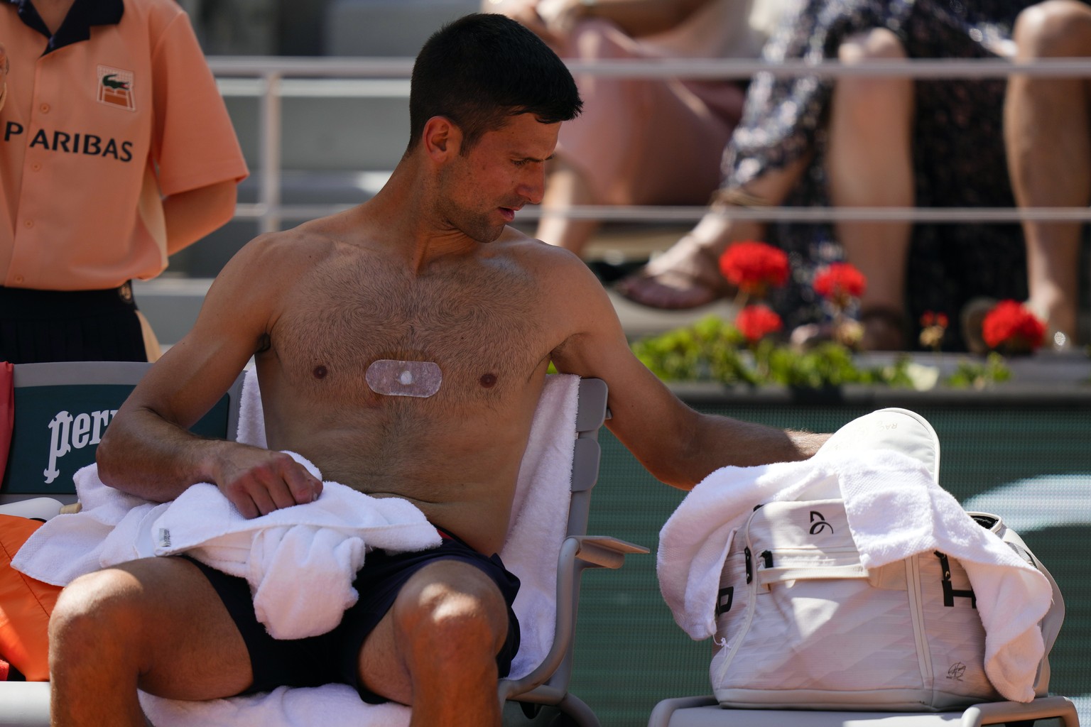 Serbia&#039;s Novak Djokovic uses a towel during the break of his fourth round match of the French Open tennis tournament against Peru&#039;s Juan Pablo Varillas, at the Roland Garros stadium in Paris ...