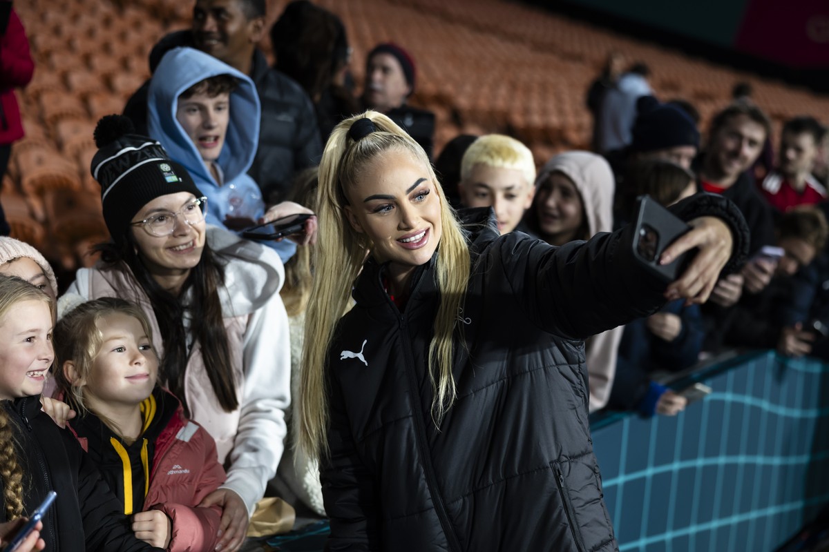 Switzerland's Alisha Lehmann, right, poses for selfies with supporters after the FIFA Women's World Cup 2023 soccer match between Switzerland and Norway at Waikato Stadium in Hamilton, New Z ...