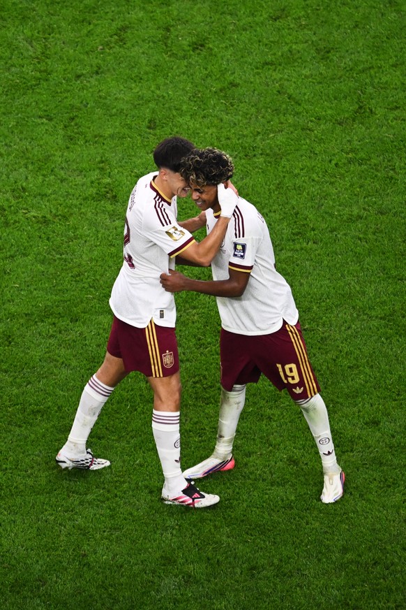 Spain's Pau Cubarsi (22) and Lamine Yamal (19) celebrate after defeating France in their World Cup semifinal soccer match in Arlington, Texas, near Dallas, Tuesday, July 14, 2026. (AP Photo/Jessi ...