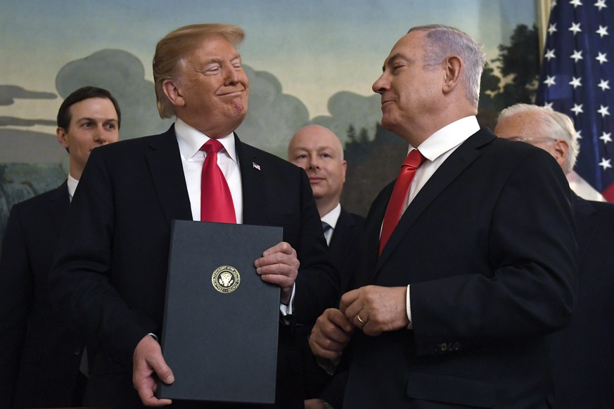 FILE - In this Monday, March 25, 2019 file photo, President Donald Trump smiles at Israeli Prime Minister Benjamin Netanyahu, right, after signing a proclamation in the Diplomatic Reception Room at th ...