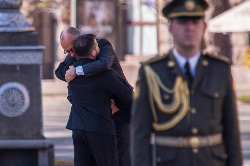 Ukraine's President Volodymyr Zelenskyy meets German Chancellor Friedrich Merz before a commemorative ceremony at the memorial of fallen Ukrainian soldiers at Independence Square in Kyiv, Ukraine ...