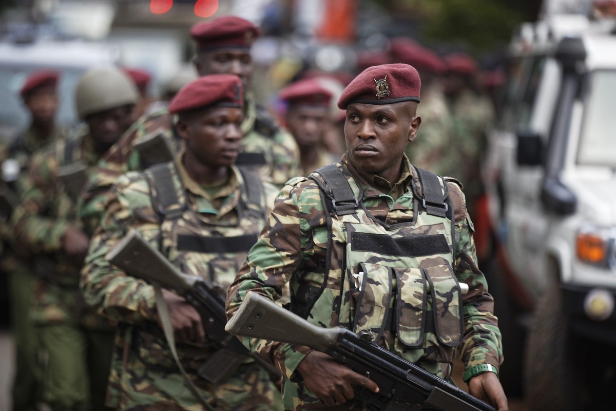 Kenyan security forces walk from the scene as continued blasts and gunfire could be heard early Wednesday, Jan. 16, 2019, in Nairobi, Kenya. Extremists stormed a luxury hotel in Kenya's capital o ...