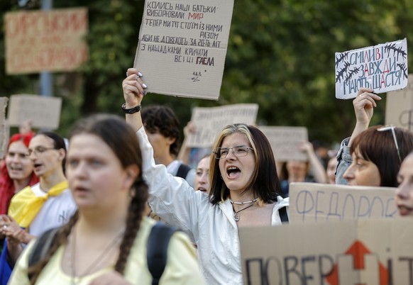 epa13127115 Ukrainians hold placards reading 'Fedorov is the defence minister', 'Don't mess with what works', 'Hands off Fedorov' and 'Bring Fedorov back', ...