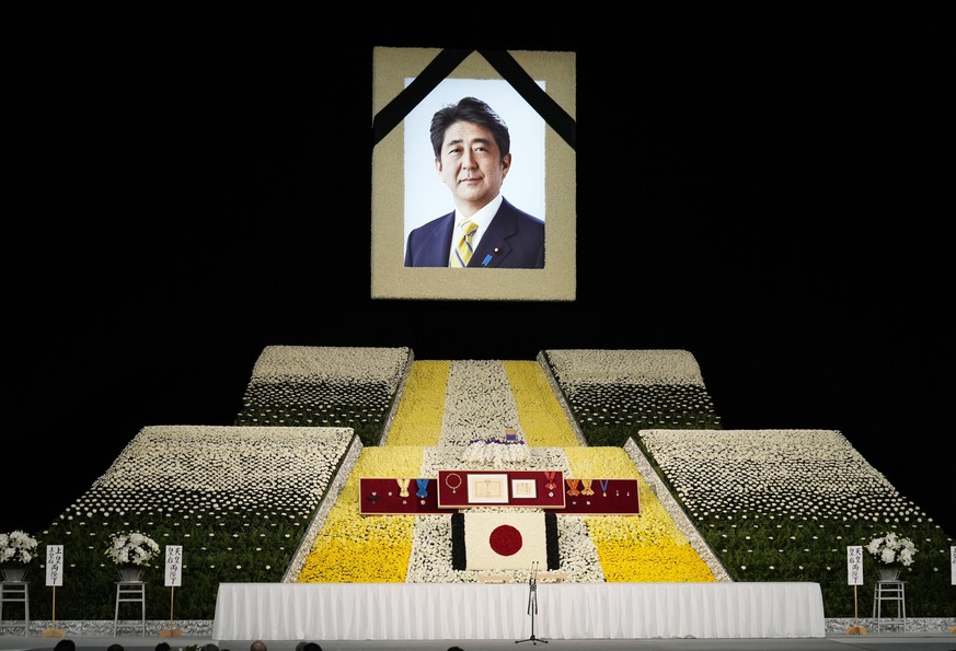 epa10208769 A portrait of Japanese Prime Minister Shinzo Abe hangs on stage at the state funeral of former Japanese Prime Minister Shinzo Abe at Nippon Budokan in Tokyo, Japan, 27 September 2022. Thou ...