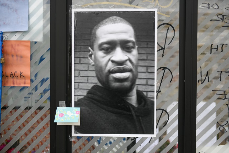 epa08453025 An image of George Floyd is on display at a makeshift memorial near the scene of the arrest of Floyd who died in police custody in Minneapolis, Minnesota USA, 29 May 2020. Floyd's life was ...