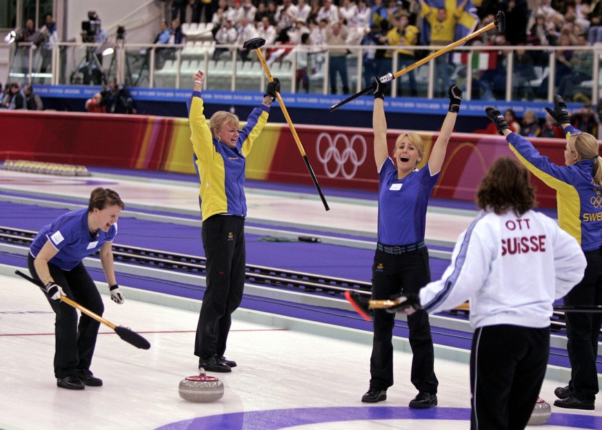 From left to right, Catherine Lindahl, Anette Norberg, Anna Svaerd, and Eva Lund celebrate their team&#039;s gold medal win after Sweden beat Switzerland 7-6 in curling during the 2006 Winter Olympics ...