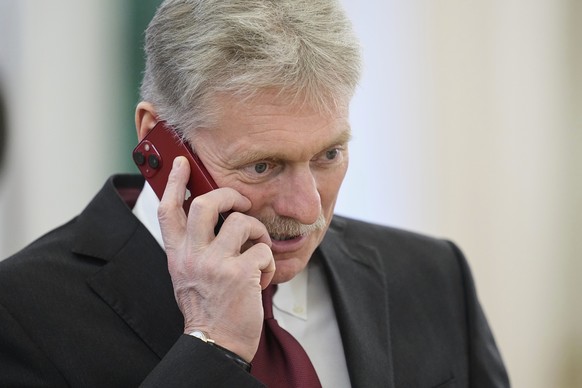 Kremlin spokesman Dmitry Peskov speaks on a phone prior to a meeting between Russian President Vladimir Putin with Zimbabwean President Emmerson Mnangagwa in the Grand Palace at the Kremlin in Moscow, ...
