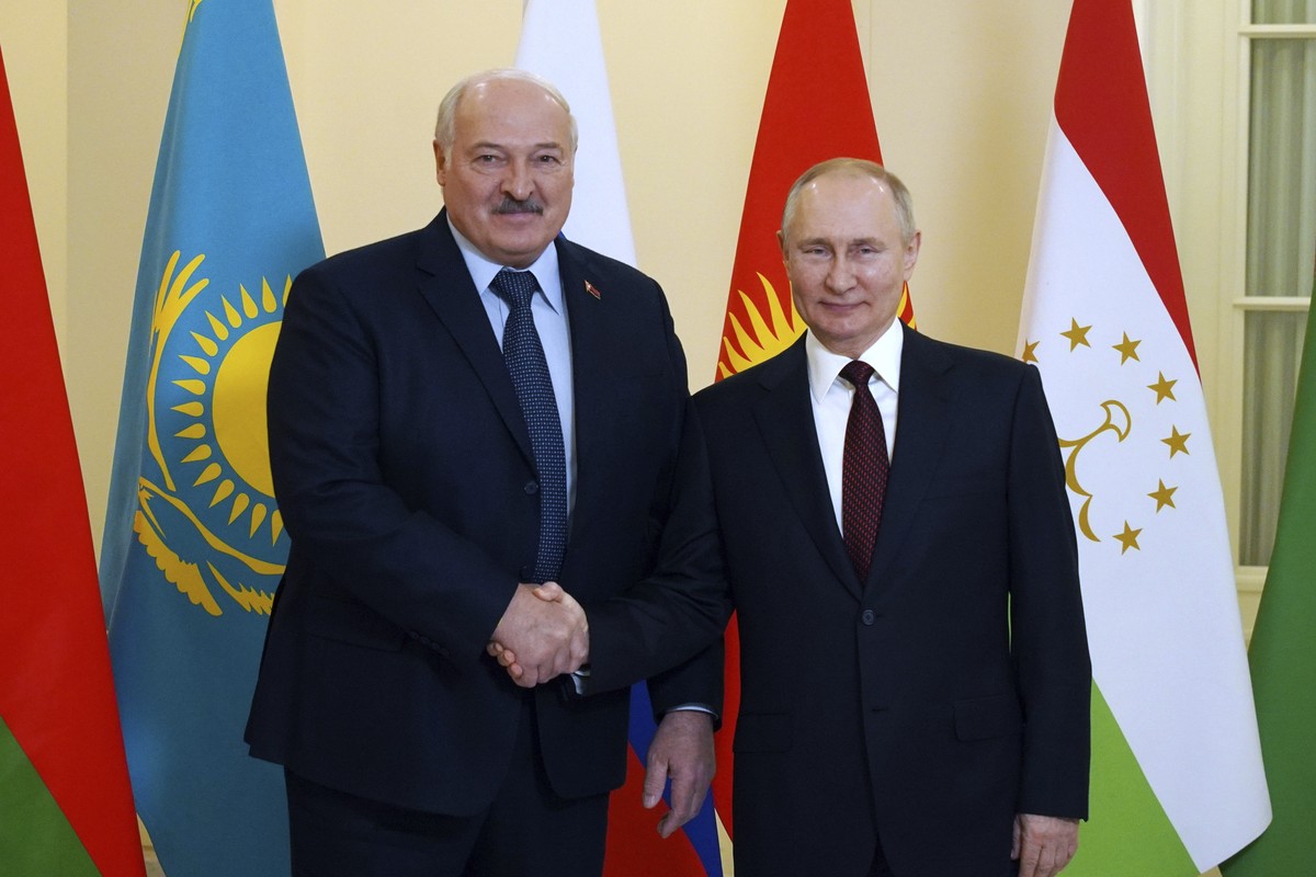 Russian President Vladimir Putin, right, and Belarusian President Alexander Lukashenko shake hands ahead of an informal meeting of the heads of ex-Soviet nations which are members of the Commonwealth  ...