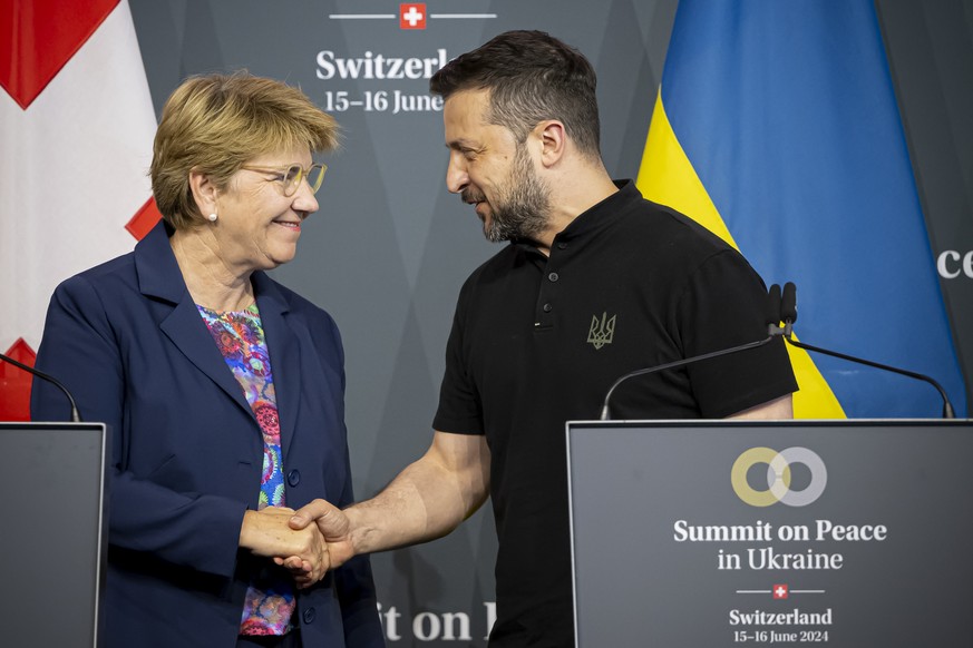 Swiss Federal President Viola Amherd (left) shakes hands with President Volodymyr Zelenskyy of Ukraine (right) during the closing press conference of the Summit on peace in Ukraine, in Stansstad near  ...