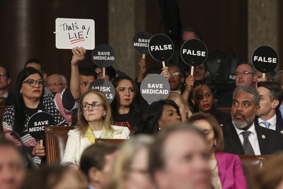 Democrats hold protest signs as President Donald Trump addresses a joint session of Congress at the Capitol in Washington, Tuesday, March 4, 2025. (Win McNamee/Pool Photo via AP)
APTOPIX Trump Speech