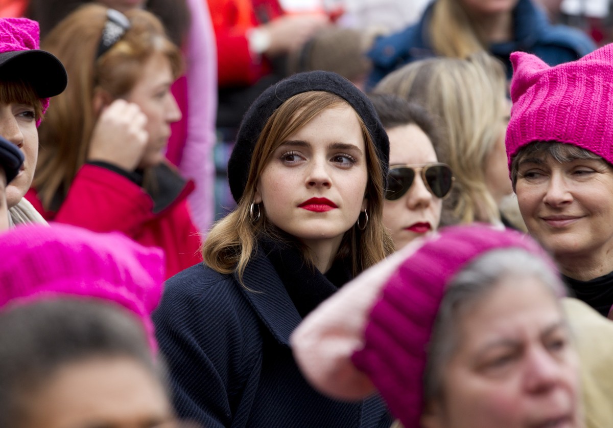 Actress Emma Watson sit with the crowd during the Women's March on Washington, Saturday, Jan. 21, 2017 in Washington. (AP Photo/Jose Luis Magana)