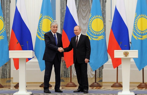 Russian President Vladimir Putin, right, and Kazakhstan's President Kassym-Jomart Tokayev shake hands after their joint news conference following the talks in the Kremlin in Moscow, Russia, Thurs ...