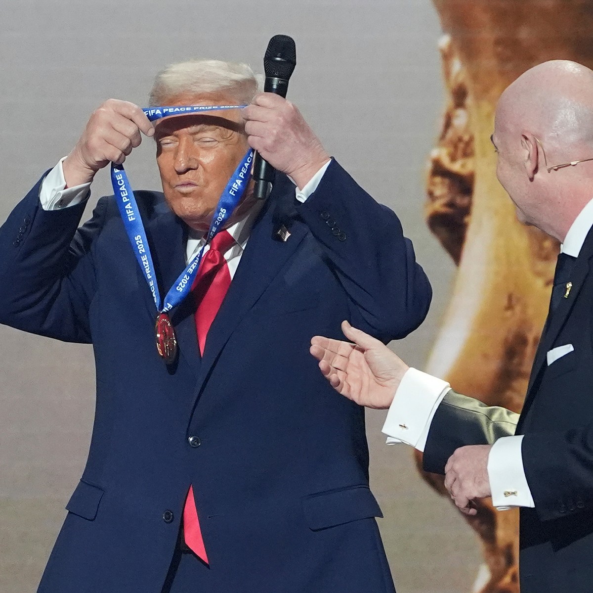 FILE - President Donald Trump is presented with the inaugural FIFA Peace Prize by FIFA President Gianni Infantino during the 2026 FIFA World Cup draw at the Kennedy Center, Dec. 5, 2025, in Washington ...