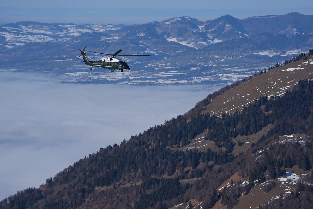 Marine One, carrying President Donald Trump, flies over snow covered mountains during his transfer to Davos after arriving at the airport in Zurich, Switzerland, Wednesday, Jan. 21, 2026. (AP Photo/Ev ...