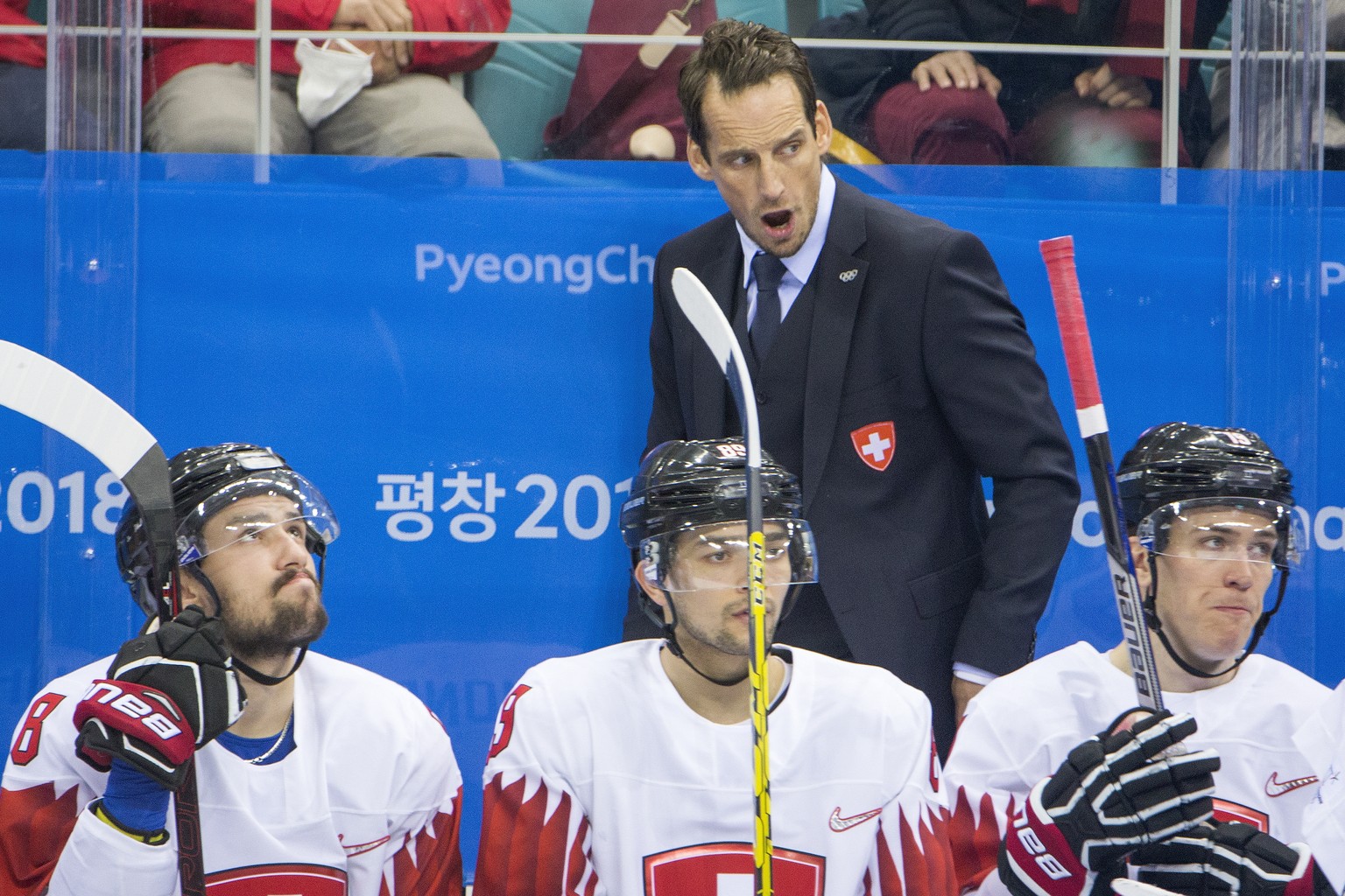 Vincent Praplan of Switzerland, $89$ Patrick Fischer, head coach of Switzerland, and Reto Schaeppi of Switzerland, from left, during the men ice hockey preliminary round match between Switzerland and  ...