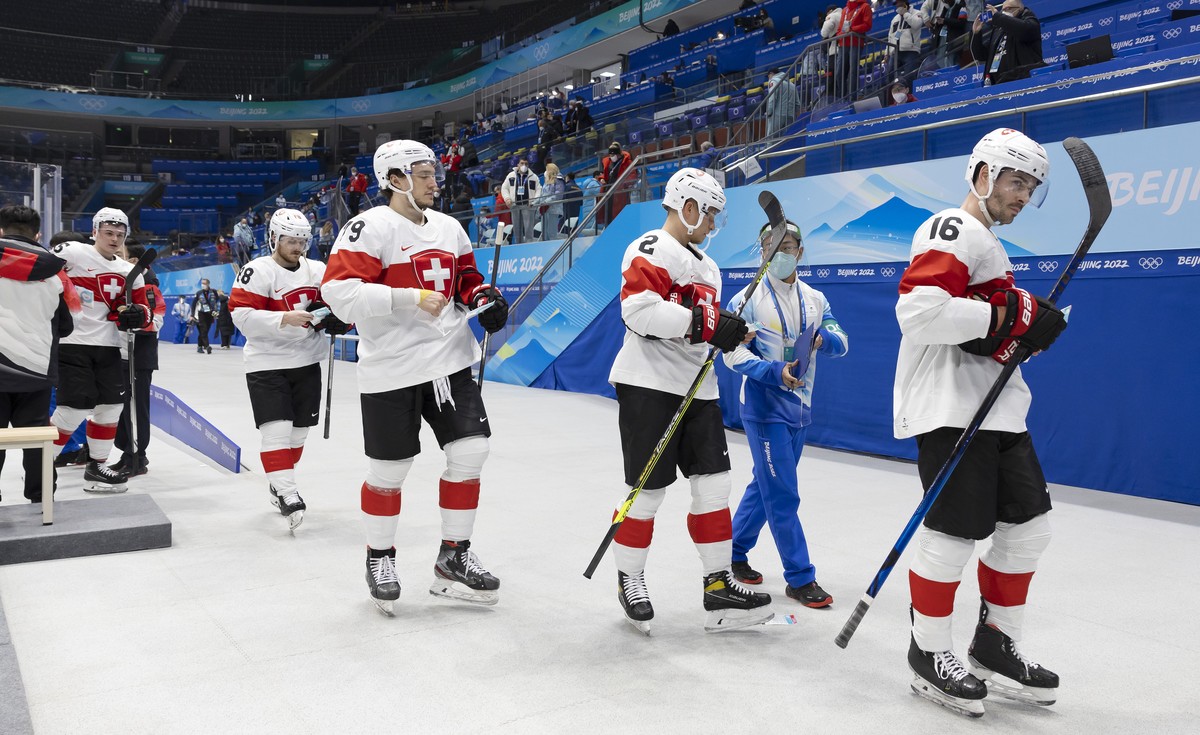Switzerland's, from left, forward Gregory Hofmann, forward Christoph Bertschy, forward Calvin Thurkauf, defender Santeri Alatalo and defender Raphael Diaz, leave the rink after losing against Rus ...