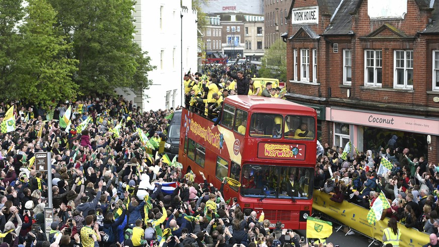 Norwich City players on a bus, during a promotion parade, in Norwich City Centre, in Norwich, England, Monday May 6, 2019. Having already secured promotion to the Premier League, Norwich added the sec ...