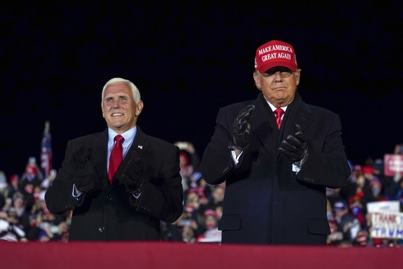 FILE - Then-President Donald Trump arrives for a campaign rally at Gerald R. Ford International Airport, Nov. 2, 2020, in Grand Rapids, Mich., with then-Vice President Mike Pence (AP Photo/Evan Vucci, ...