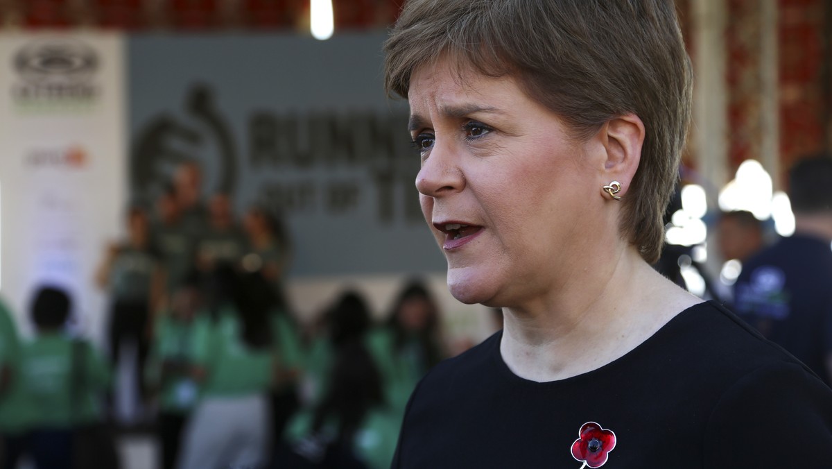 FILE - Scotland's First Minister Nicola Sturgeon speaks to members of the media at the finish line of the Running Out Of Time climate relay, which arrived from Glasgow, Scotland, after 40 days th ...