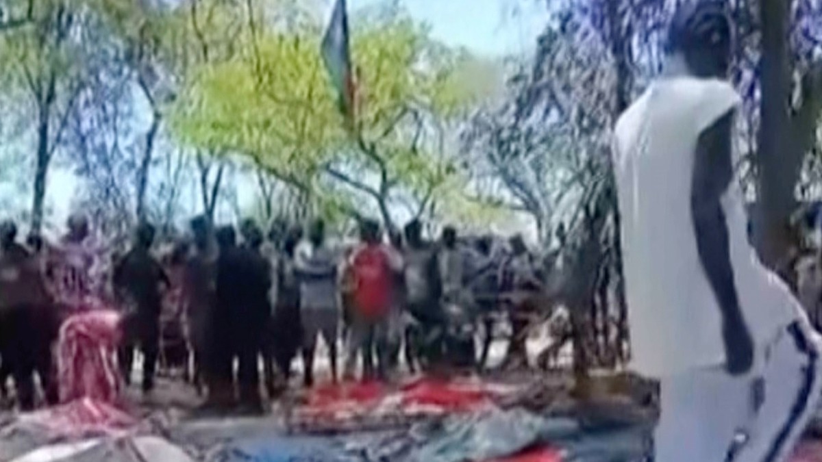 In this image made from video, dead bodies are seen covered on the ground, after gunmen killed more than 70 people in South Sudan over a gold mining row on the outskirts of the capital, in Jebel Iraq, ...