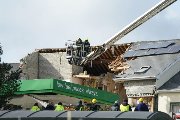 Emergency services work at the scene of an explosion at Applegreen service station in the village of Creeslough in Co Donegal, Ireland, Saturday, Oct. 8, 2022. Authorities say at least seven people ha ...