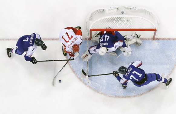 Russian athlete Ilya Kovalchuk (71) tries to shoots against Ivan Baranka (7) and Marek Daloga (71), of Slovakia, as Branislav Konrad (42) defends the goal during the third period of the preliminary ro ...