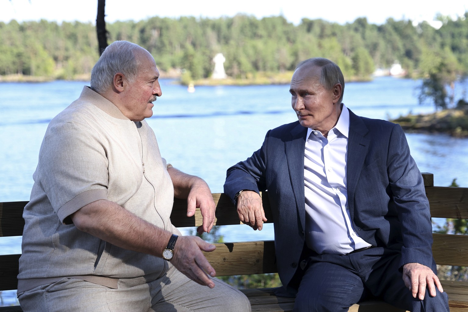 Russian President Vladimir Putin, right, and Belarusian President Alexander Lukashenko talk to each other during a visit to the Chapel of the Valaam Icon of the Mother of God on the Svetly Island in t ...