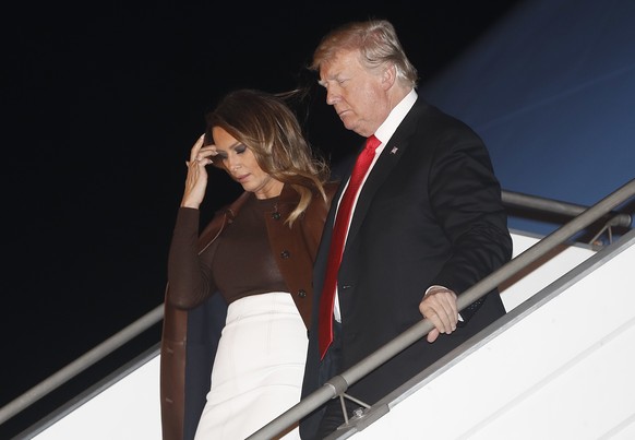 President Donald Trump and first lady Melania Trump walk from Air Force One, Thursday, Nov. 29, 2018, as they arrive at the Ministro Pistarini international airport in Buenos Aires, Argentina. Trump t ...