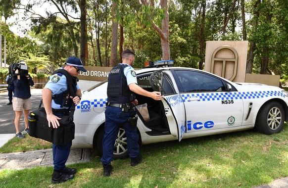 epa07259093 New South Wales police place evidence bags into a car at the scene of a double stabbing at the Church of Scientology headquarters in Chatswood, Sydney, Australia, 03 January 2019. EPA/MICK ...