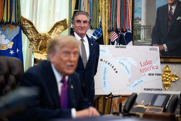 epa13195388 A poster shows the name change from Lake Ontario to Lake America, as US President Donald Trump signs an executive order on the renaming, amid a recent trade war, in the Oval Office of the  ...