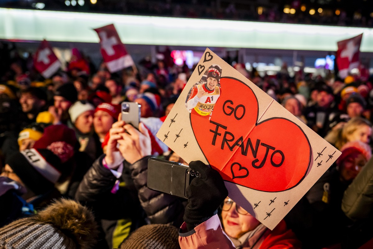 Fans celebrate for the winner Franjo von Allmen of Switzerland during the price giving ceremony of the men's Downhill race at the Alpine Skiing FIS Ski World Cup, in Crans-Montana, Switzerland, S ...