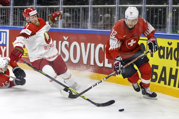 Belarus&#039; defender Vladimir Denisov, left, vies for the puck with Switzerland&#039;s forward Gaetan Haas, right, during the IIHF 2018 World Championship preliminary round game between Switzerland  ...