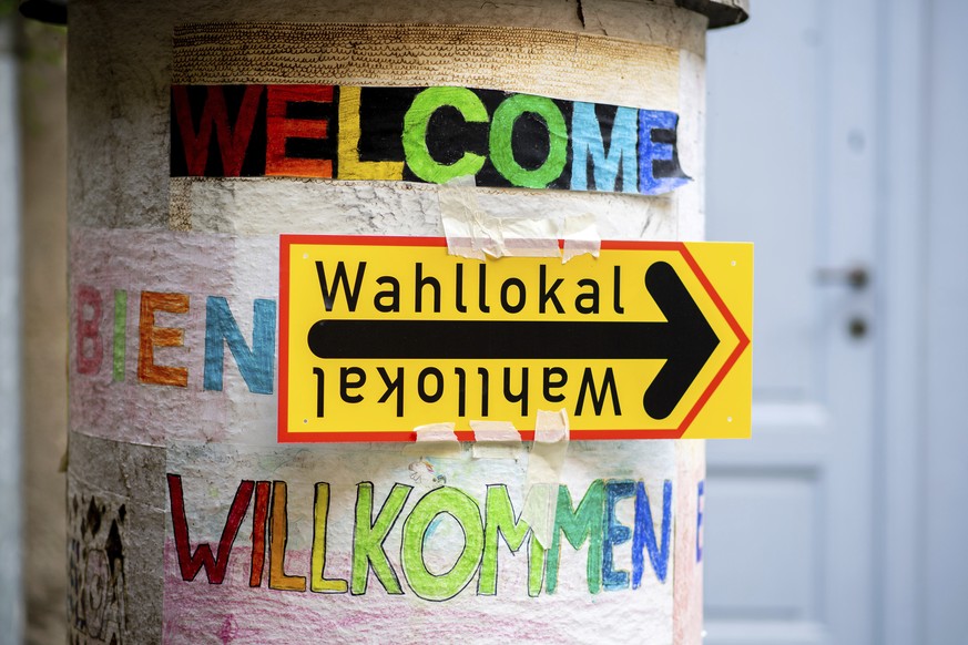 A sign reading &quot;Wahllokal&quot; (polling station) hangs on a pillar in the Prenzlauer Berg district of Berlin in the courtyard of an elementary school that houses a polling station, Sunday, Sept. ...