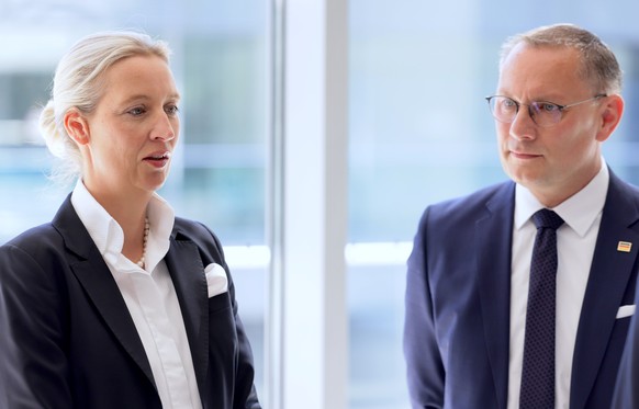 epa12096545 Alternative for Germany (AfD) party and faction co-chairs Alice Weidel (L) and Tino Chrupalla wait before a news conference prior to a faction meeting at the German Bundestag (Parliament)  ...
