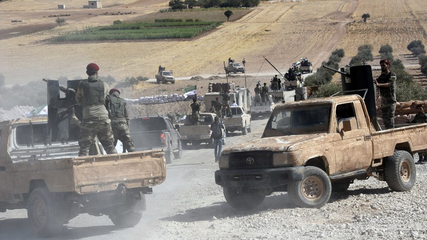 Turkey-backed FSA fighters are heading toward Syrian town of Tal Abyad from Turkish border town of Akcakale, Turkey, Thursday, Oct. 10, 2019. Turkish President Recep Tayyip Erdogan says that there hav ...