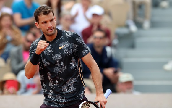 epa07610296 Grigor Dimitrov of Bulgaria plays Marin Cilic of Croatia during their menâs second round match during the French Open tennis tournament at Roland Garros in Paris, France, 29 May 2019. EP ...