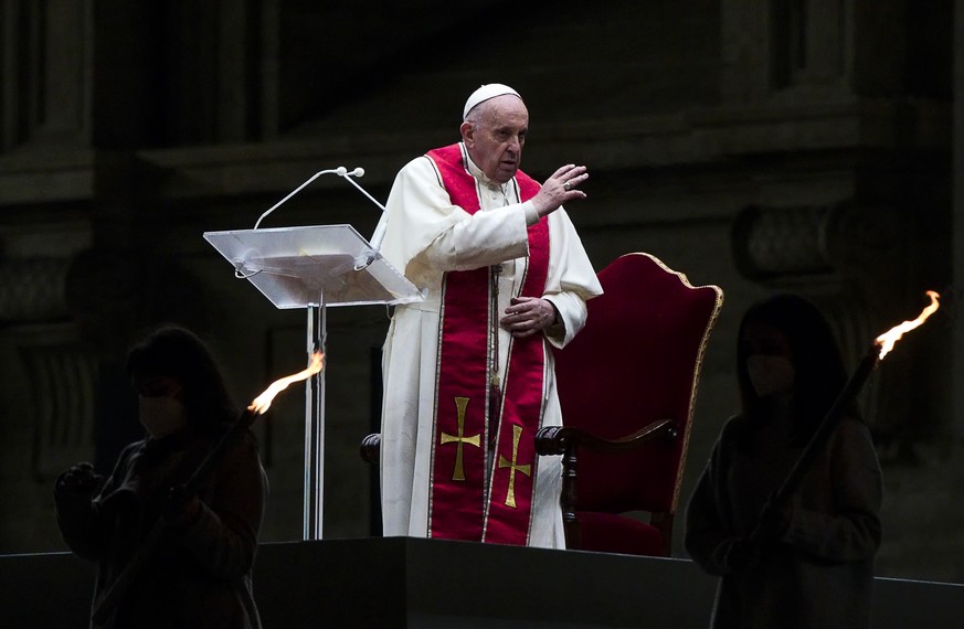 Pope Francis leads the Via Crucis (Way of the Cross) procession in the empty square outside the Saint Peter&#039;s Basilica during Good Friday celebrations at the Vatican, with no public participation ...