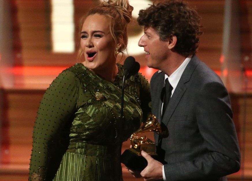 Adele and co-song writer Greg Kurstin accept the Grammy for Song of the Year for &quot;Hello&quot; at the 59th Annual Grammy Awards in Los Angeles, California, U.S. , February 12, 2017. REUTERS/Lucy N ...